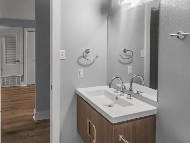 bathroom with vanity and hardwood / wood-style floors