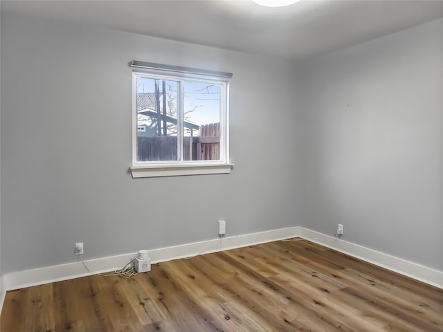 unfurnished room with hardwood / wood-style floors