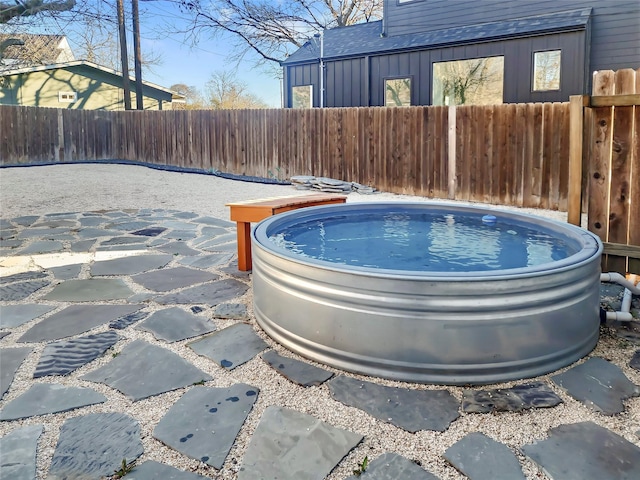 view of swimming pool with a hot tub and a patio