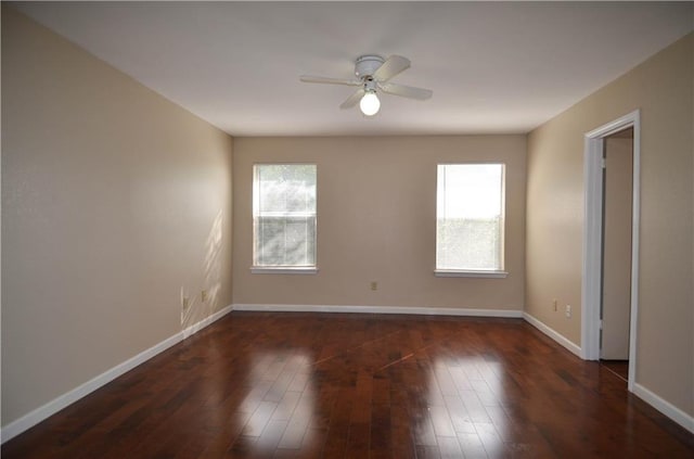 unfurnished room with dark hardwood / wood-style floors and ceiling fan