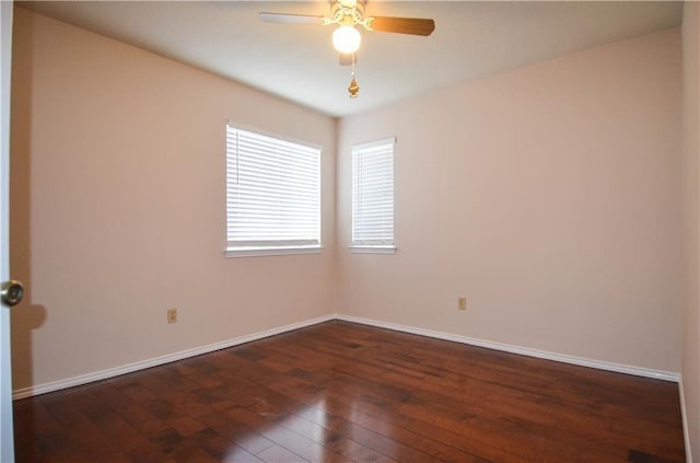 spare room featuring dark hardwood / wood-style flooring and ceiling fan