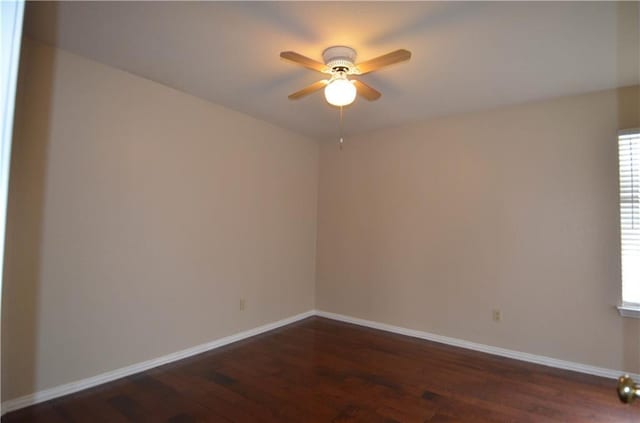 empty room featuring ceiling fan and dark wood-type flooring