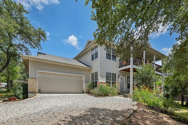 view of front of property with a garage and a balcony