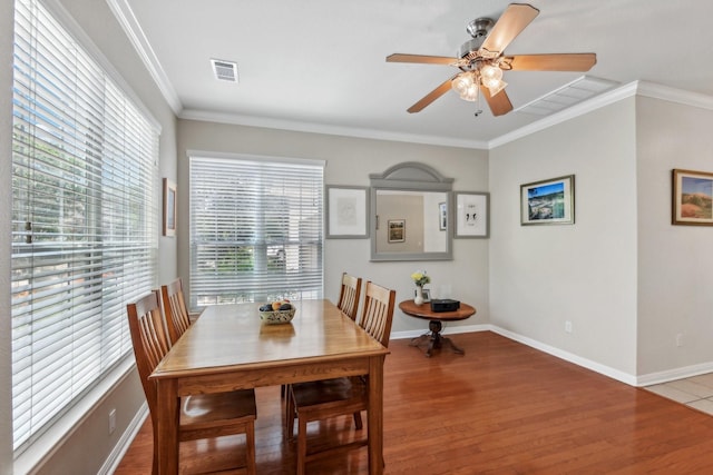 dining space featuring hardwood / wood-style flooring, ceiling fan, and ornamental molding