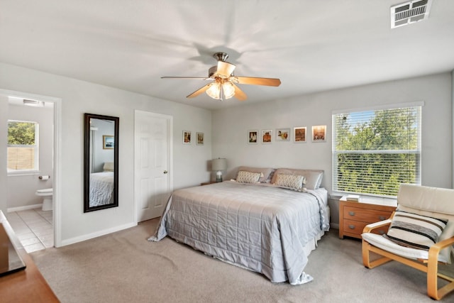 carpeted bedroom with ceiling fan and ensuite bathroom