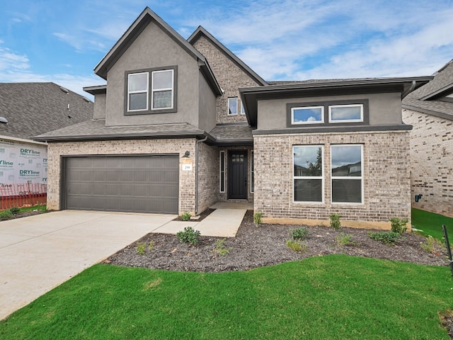 view of front of property featuring a garage and a front yard