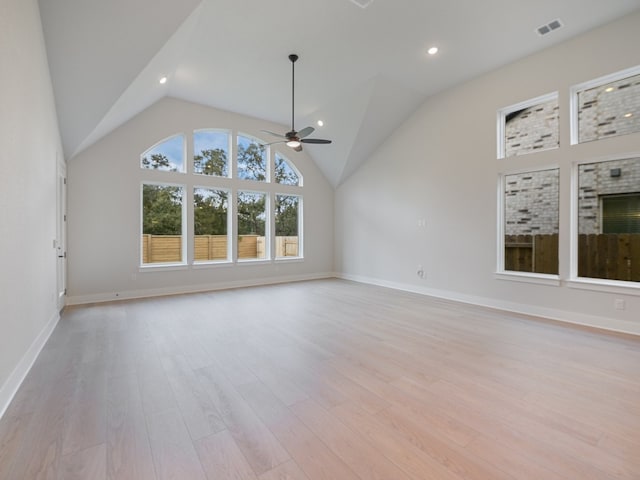 unfurnished living room with light wood-type flooring, lofted ceiling, and ceiling fan