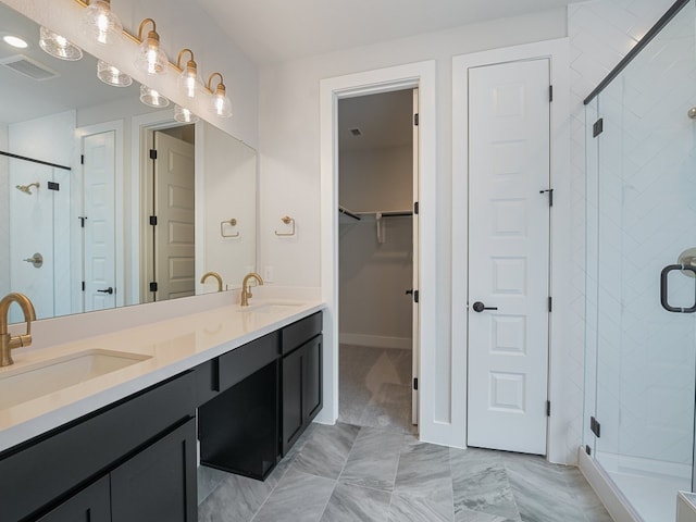 bathroom featuring vanity and a shower with door