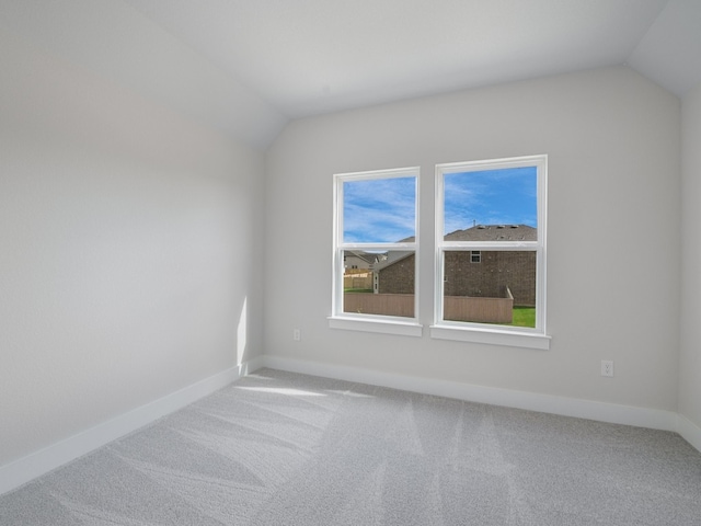 spare room with lofted ceiling and carpet floors