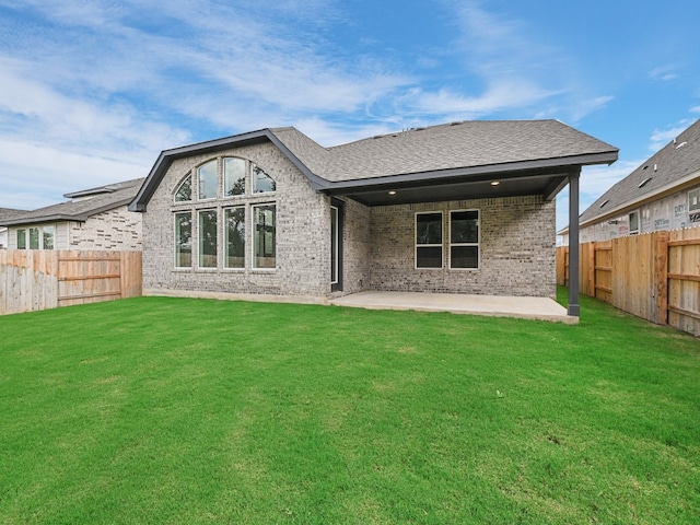 back of property featuring a patio and a yard