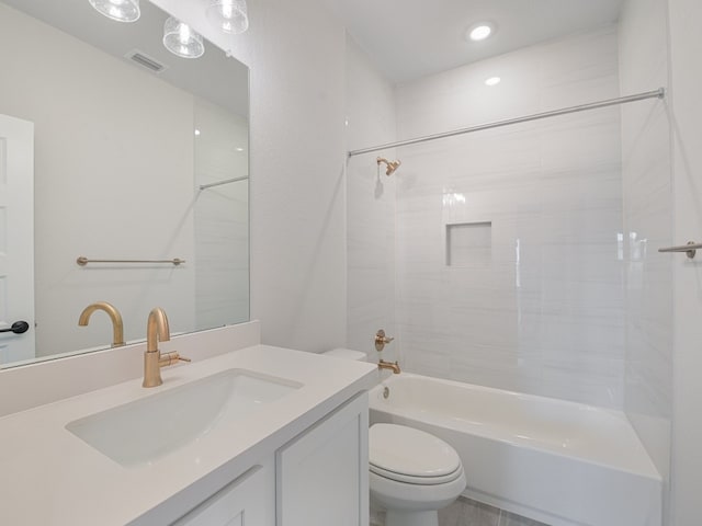 full bathroom with vanity, tiled shower / bath, and toilet