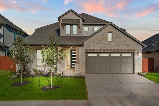 view of front of home with a garage and a yard