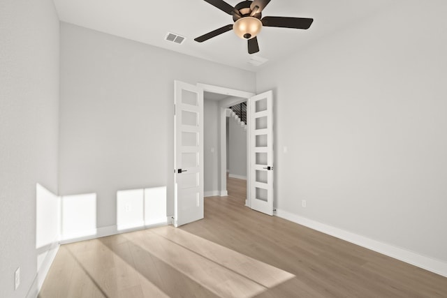 spare room featuring light wood-type flooring and ceiling fan