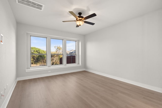 empty room featuring ceiling fan and wood-type flooring