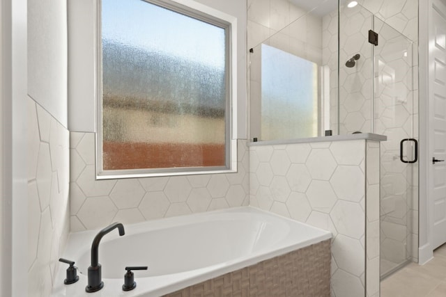 bathroom featuring a healthy amount of sunlight and plus walk in shower