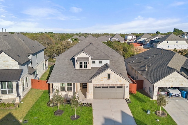 view of front of home with a garage and a front lawn