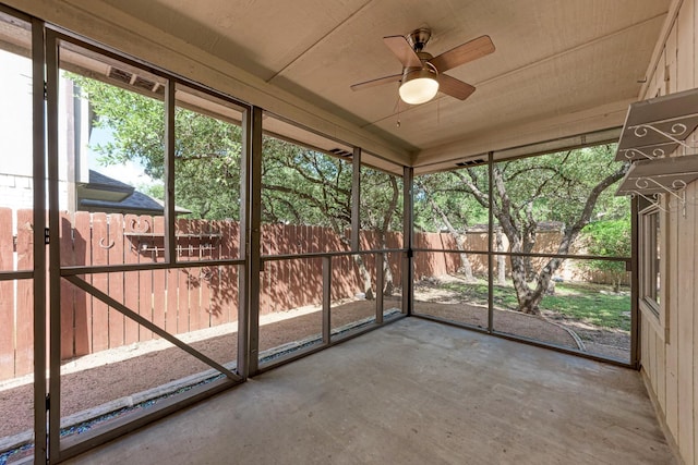 unfurnished sunroom featuring ceiling fan