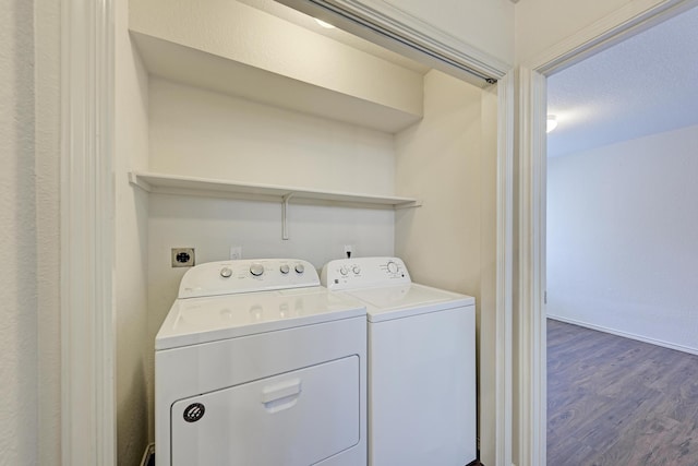 laundry area with a textured ceiling, hardwood / wood-style flooring, and washing machine and clothes dryer