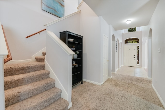 stairs featuring light colored carpet