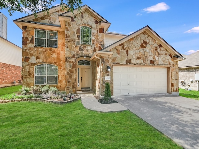 view of front of home with a garage and a front lawn