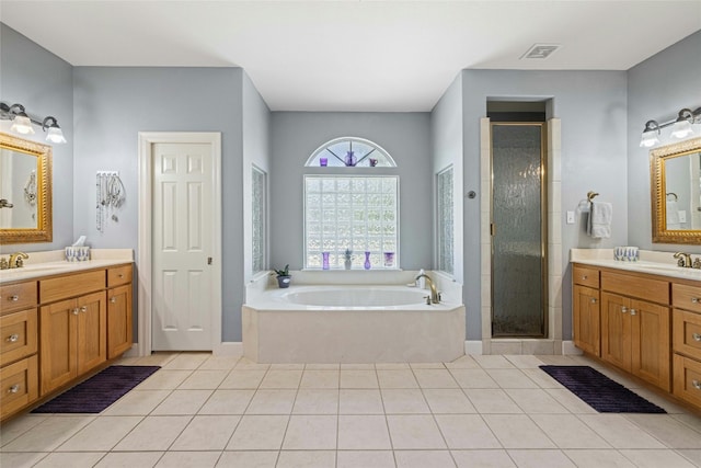 bathroom with tile patterned flooring, vanity, and shower with separate bathtub