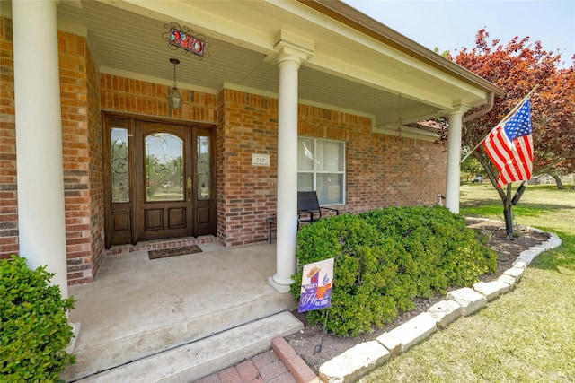 view of exterior entry with a porch