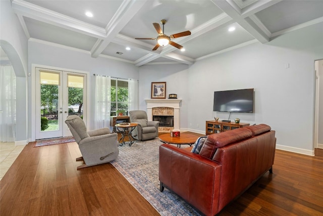 living room featuring french doors, coffered ceiling, ceiling fan, beamed ceiling, and wood-type flooring