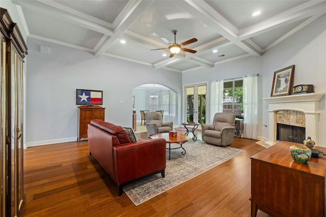 living room featuring a fireplace, beam ceiling, french doors, and coffered ceiling