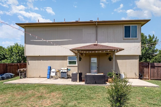 back of house with a yard and a patio