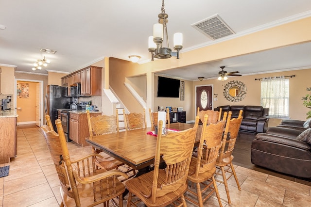 dining area featuring ceiling fan with notable chandelier, light tile patterned flooring, and ornamental molding