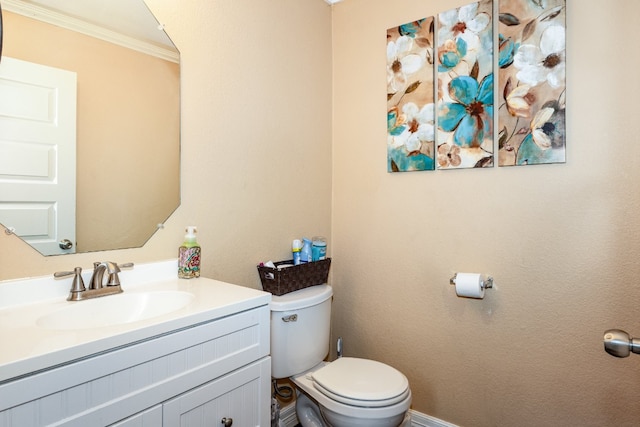 bathroom featuring crown molding, vanity, and toilet