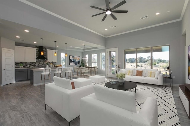 living room featuring crown molding, ceiling fan, and dark wood-type flooring