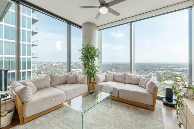 sunroom featuring a healthy amount of sunlight and ceiling fan