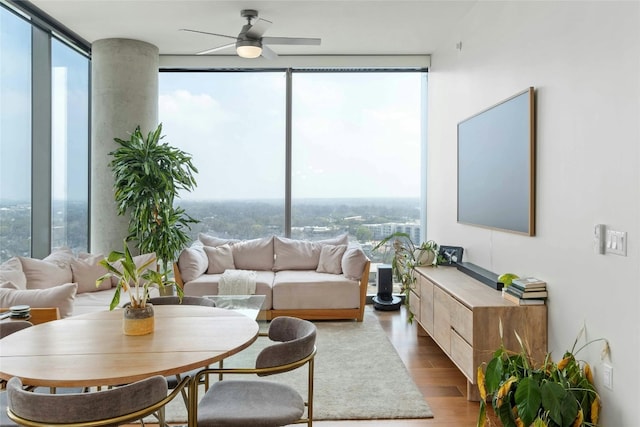 44 E Ave Unit 1507, Austin, TX 78701 - living area with expansive windows, wood finished floors, and ceiling fan