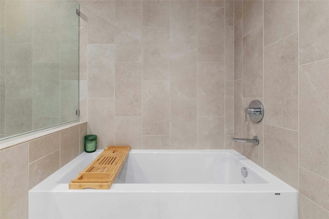 44 E Ave Unit 1507, Austin, TX 78701 - full bathroom with a tub and tile walls