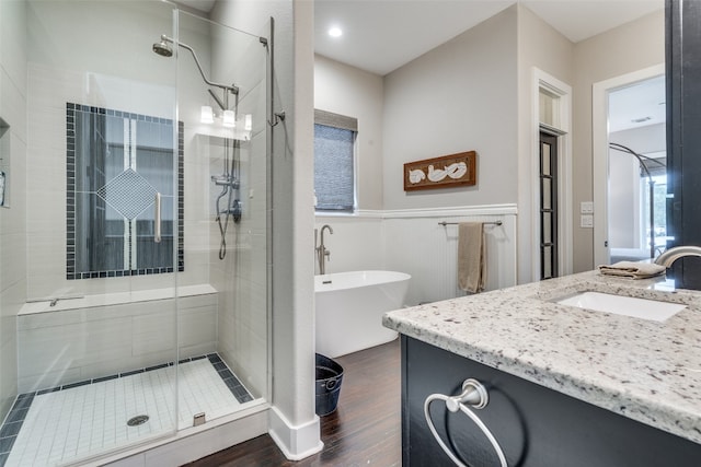 bathroom with wood-type flooring, vanity, and an enclosed shower