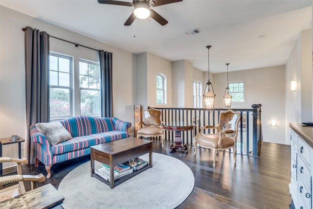 living room with dark hardwood / wood-style floors, a healthy amount of sunlight, and ceiling fan