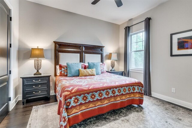 bedroom with ceiling fan and dark hardwood / wood-style flooring