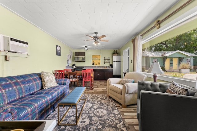 living room featuring hardwood / wood-style floors, a wall mounted air conditioner, and ceiling fan