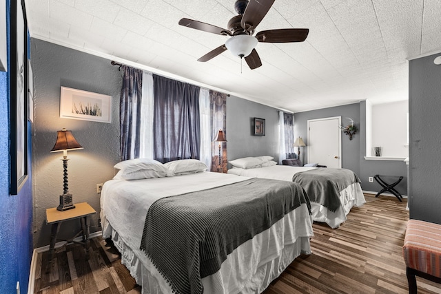 bedroom with ceiling fan and dark wood-type flooring