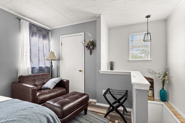 bedroom featuring ornamental molding and hardwood / wood-style floors