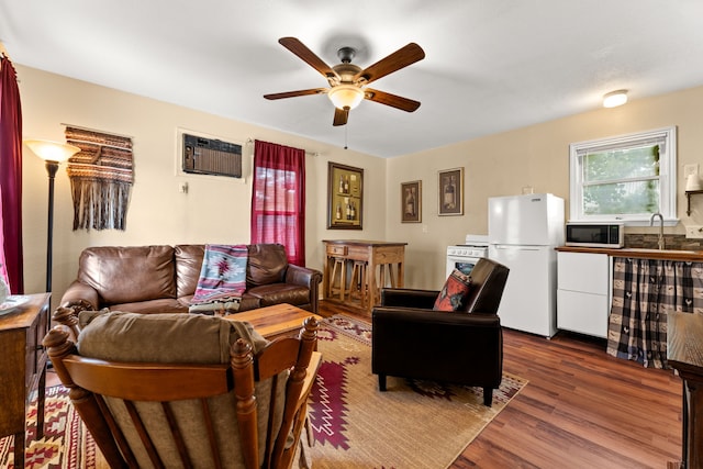 living room featuring sink, a wall mounted air conditioner, ceiling fan, and hardwood / wood-style floors