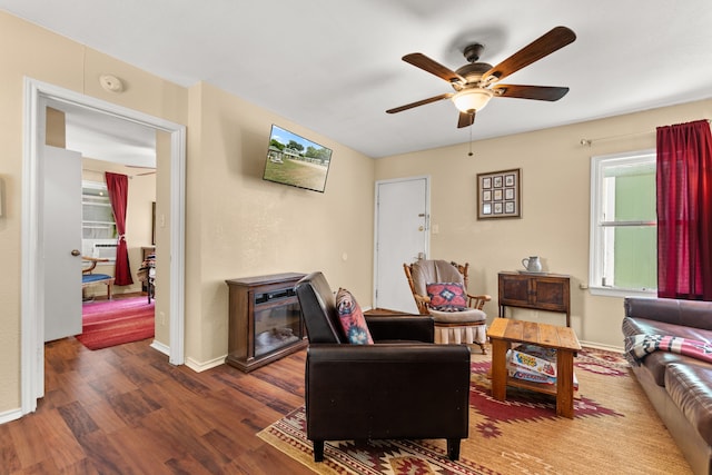 living room with ceiling fan and dark hardwood / wood-style flooring