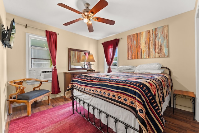 bedroom with ceiling fan, cooling unit, and dark hardwood / wood-style floors