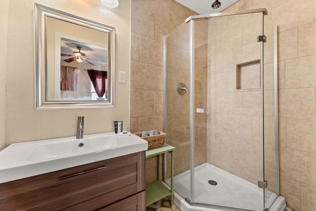 bathroom with a shower with door and vanity