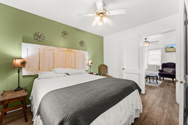 bedroom with dark hardwood / wood-style floors and ceiling fan