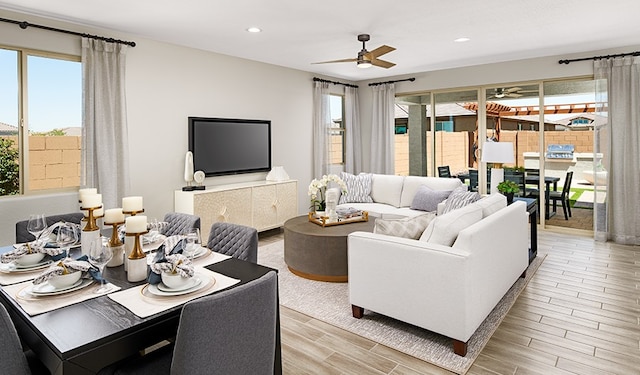 living room with ceiling fan and light wood-type flooring