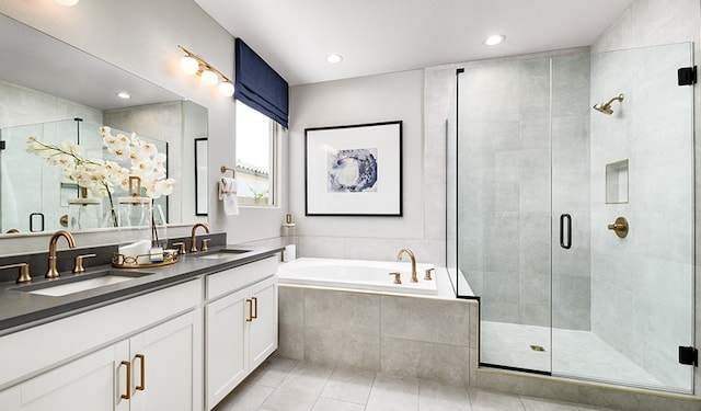 bathroom with tile patterned flooring, vanity, and separate shower and tub