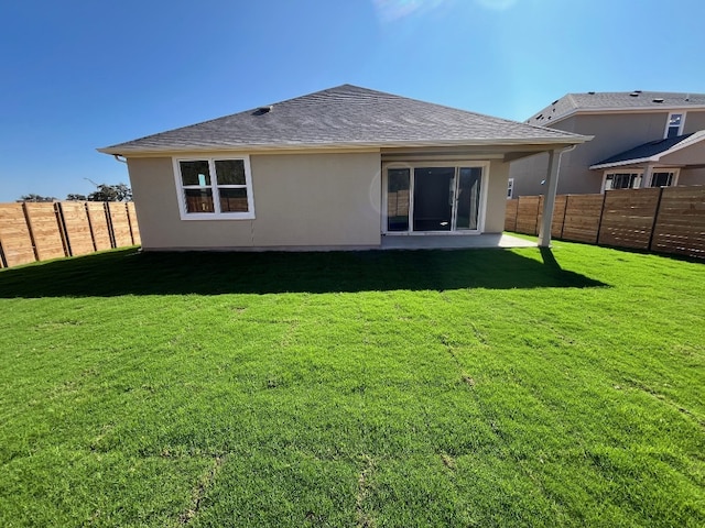 back of property featuring a yard and a patio area