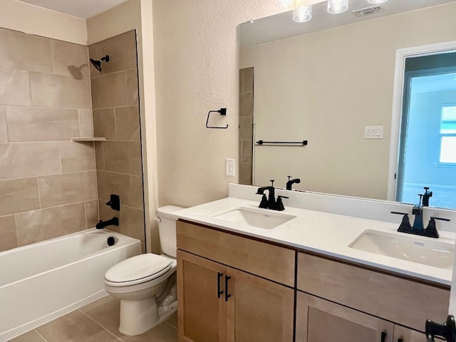 full bathroom featuring toilet, tile patterned flooring, vanity, and tiled shower / bath